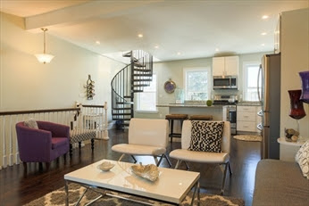 A living room with white walls and furniture.