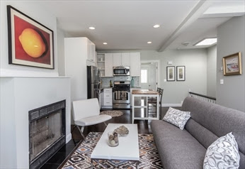 A living room with a couch and fireplace in it