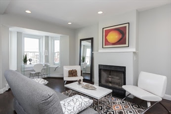 A living room with a fireplace and a couch
