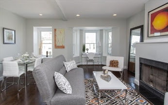 A living room with a couch, table and chair.